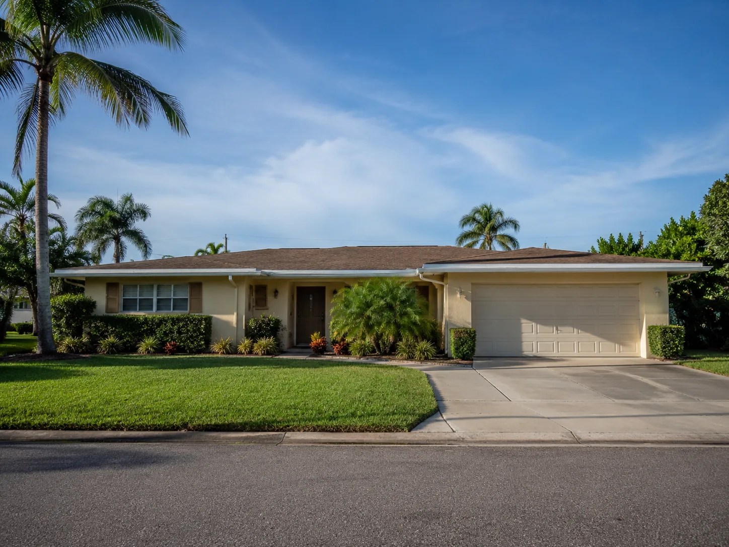 Exterior of the 1974 Satellite Beach single-story home with palm trees